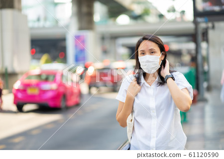 Woman wearing face mask protect filter against air 61120590