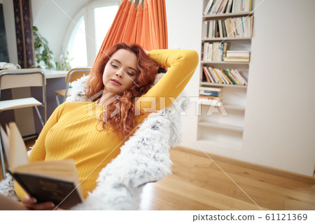 redhead woman relaxing at home in cozy winter or 61121369