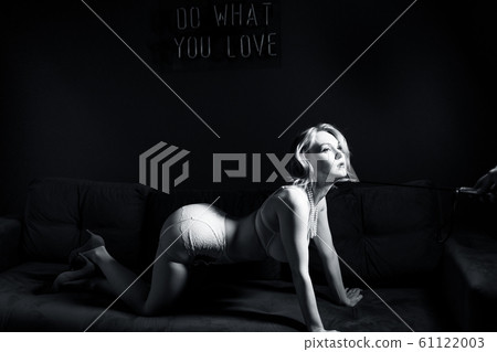 Blonde submissive woman slave is kneeling. Blonde submissive woman slave is kneeling. 61122003