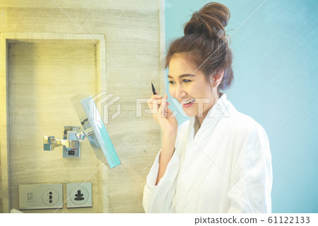 Beautiful Asian woman using eyebrow pencil make up 61122133