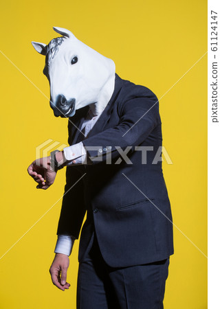 man with horse mask on yellow background man with horse mask on yellow background 61124147