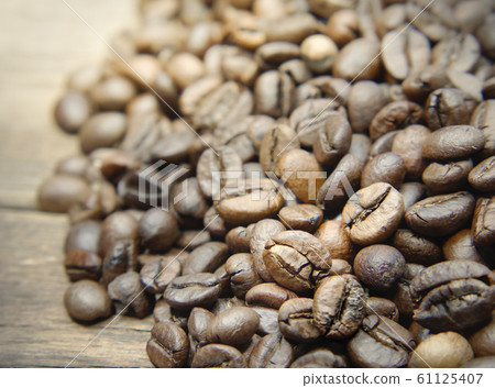 Whole coffee beans on wooden background. 61125407