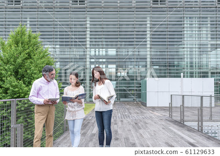 Female college student who talks outdoors and a professor college campus life Female college student who talks outdoors and a professor college campus life 61129633