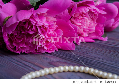 Close-up flowers peonies and pearl necklace. Close-up flowers peonies and pearl necklace. 61130644