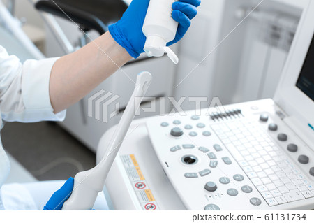 gynecologist doctor prepares an ultrasound machine 61131734