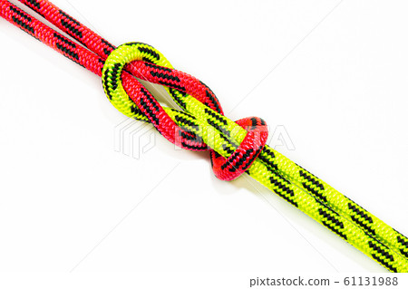 Reef, Hercules, square, double or brother hood Binding knot binding two colored (red and green) ropes. nautical loop used to secure rope or fishing line around an object. Isolated on white background Reef, Hercules, square, double or brother hood Binding knot binding two colored (red and green) ropes. nautical loop used to secure rope or fishing line around an object. Isolated on white background 61131988