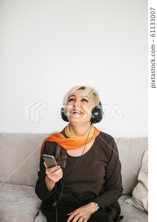 Elderly woman listening to music 61133007