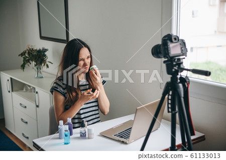 Girl videoblogger records video. 61133013