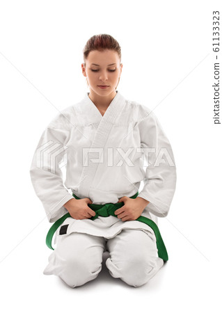 Young girl wearing kimono in meditative stance Young girl wearing kimono in meditative stance 61133323