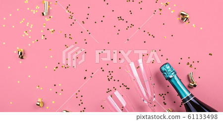 Champagne bottle and flutes on pink. Confetti Champagne bottle and flutes on pink. Confetti 61133498