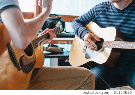 Learning to play the guitar. 61133636