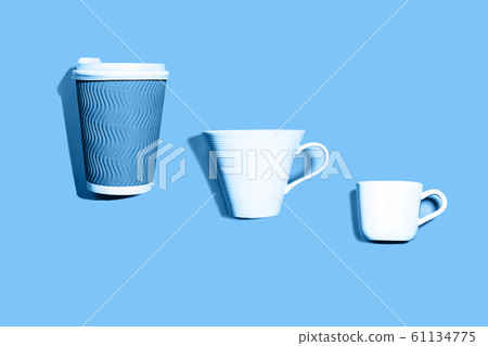 Coffee pattern of white ceramic and blue paper cup for coffee on classic blue background. Coffee pattern of white ceramic and blue paper cup for coffee on classic blue background. 61134775