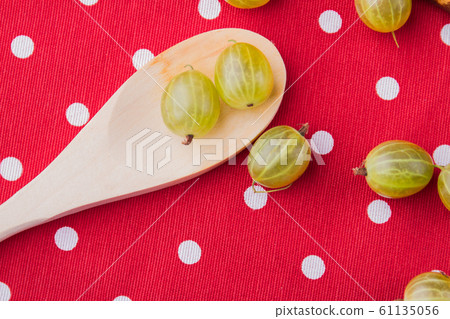 Tablespoon with a few cherry-plums. 61135056