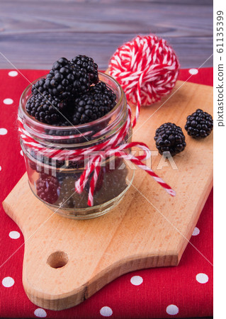 Transparent jar of blackberries. 61135399