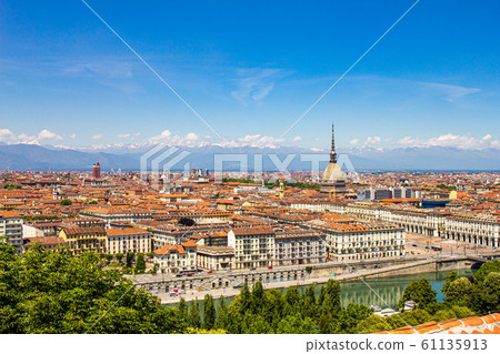 Aerial PAnoramic summer view on Turin skyline, with the city center, Po river, Mole Antonelliana, modern skyscrapers and other landmark seen from viewpoint the Monte dei Cappuccini on snowy alps Italy 61135913
