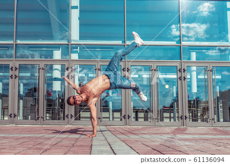 Male dancer dancing in summer city, break dance, fashionable and modern hip-hop dance style. Street lifestyle. Free space for copy text. 61136094