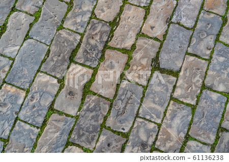 Background of stone pavement on the road in the Portuguese city of Albufeira. 61136238