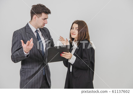 Cute young secretary brought document, which boss has to sign, but he doesn't understand and don't want to sign, frowning. 61137602