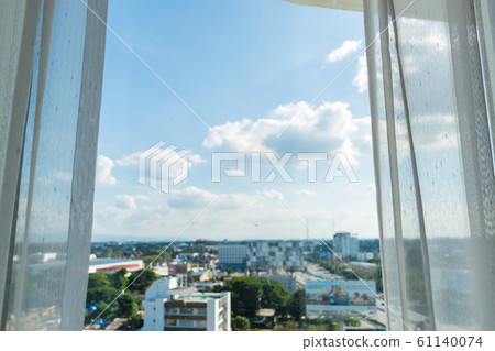 white curtain on window with view of city in the room white curtain on window with view of city in the room 61140074
