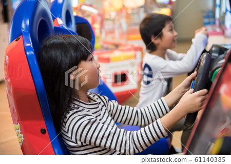 Kids playing in arcade Kids playing in arcade 61140385