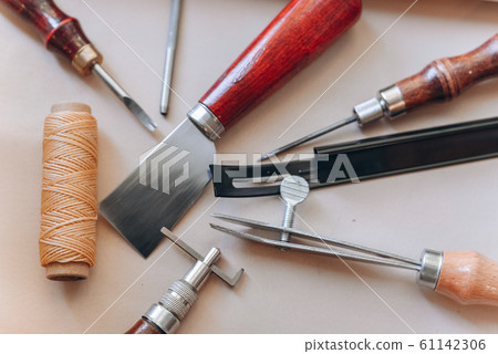 set of leathercraft tools - Slickers, Nylon hammers, Edge Creaser, Burnishers, Swivel knifes, Edge Beveler Skiving, Prongs Lacing Stitching Chisels isolated on white background 61142306