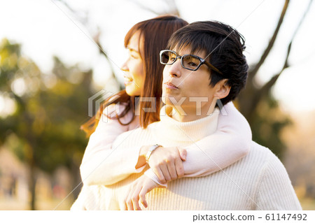 A couple carrying on the back image sunset A couple carrying on the back image sunset 61147492