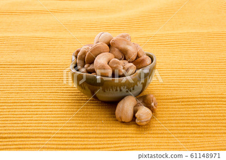 nuts or cashew nuts on the background new. nuts or cashew nuts on the background new. 61148971