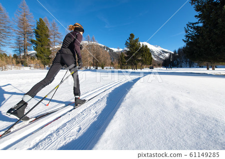 Girl practices Nordic skiing with alternating step Girl practices Nordic skiing with alternating step 61149285