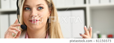Portrait of happy smiling young doctor in headset 61150373
