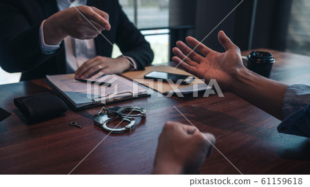 police officer presenting evidence to suspect 61159618