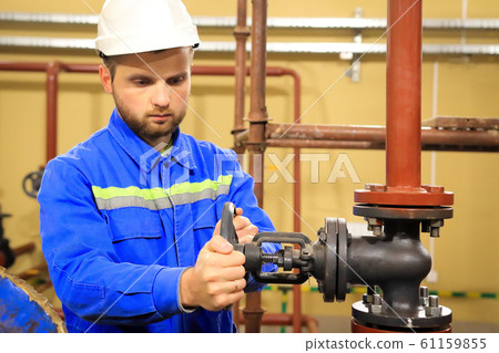 Maintenance engineer  turns a main valve and 61159855