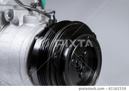 Close-up New car air conditioning compressor on grey background Close-up New car air conditioning compressor on grey background 61162539