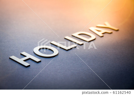 Word holiday written with white solid letters Word holiday written with white solid letters 61162540
