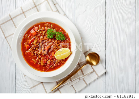 lentil soup with vegetables and lemon wedges lentil soup with vegetables and lemon wedges 61162913