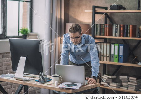 Young bearded office worker having a busy day Young bearded office worker having a busy day 61163074