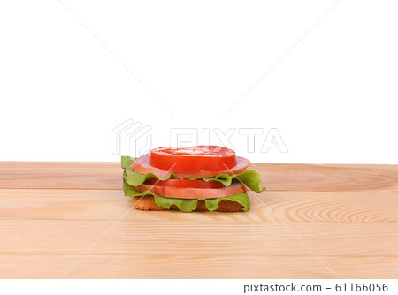 big sandwich with fresh vegetables on wooden board 61166056