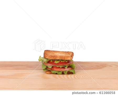 big sandwich with fresh vegetables on wooden board 61166058