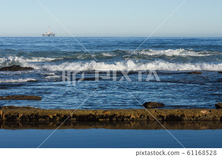 Seashore Tidal Pool And Rocks With Offshore Platform Seashore Tidal Pool And Rocks With Offshore Platform 61168528