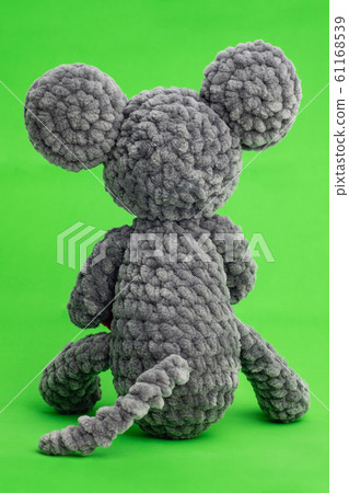 Grey knitted mouse with a heart in hand on a green Grey knitted mouse with a heart in hand on a green 61168539