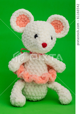 Knitted toy mouse on a green background 61168542