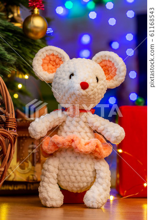 Knitted toy white mouse in a sunface under a 61168543