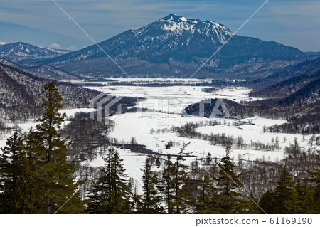 Ozegahara and Hiuchigatake with residual snow seen from the hillside of Mt. Ozegahara and Hiuchigatake with residual snow seen from the hillside of Mt. 61169190