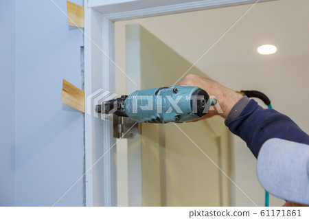 Worker in using air nail gun installing the 61171861
