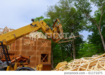 New construction home framing against a boom truck 61171875