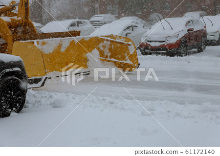 snowplow removing snow from parking for cars snowplow removing snow from parking for cars 61172140