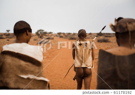 original native bushman from Namibia with traditional clothing from behind original native bushman from Namibia with traditional clothing from behind 61178192
