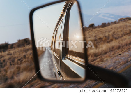look back into the side mirror of a van car look back into the side mirror of a van car 61178371
