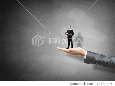 Palm supporting businessman 61180426