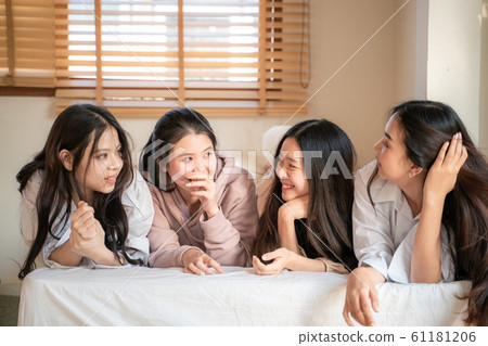 Happy beautiful young asian women talking and use Happy beautiful young asian women talking and use 61181206