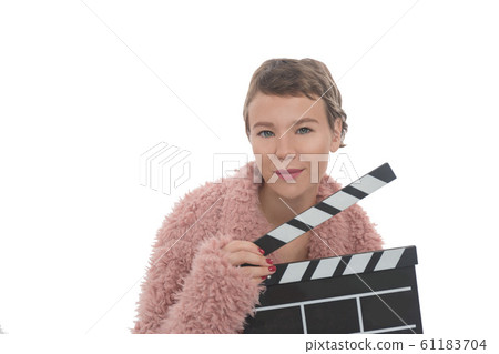 Beautiful girl in pink fur coat holding a Clapper board isolated on white background. Beautiful girl in pink fur coat holding a Clapper board isolated on white background. 61183704
